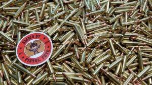 Loose remanufactured rifle ammo pile with a sticker that says Ammo by Pistol Pete and has a character holding two guns in the air.