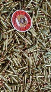 Loose remanufactured rifle ammo pile with a sticker that says Ammo by Pistol Pete and has a character holding two guns in the air.