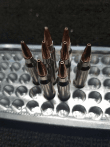 8 rounds of 223 Rem 75 grain Boat Tail Hollow Points Remanufactured Bulk Rifle Ammo in an ammo tray, manufactured by Ammo by Pistol Pete